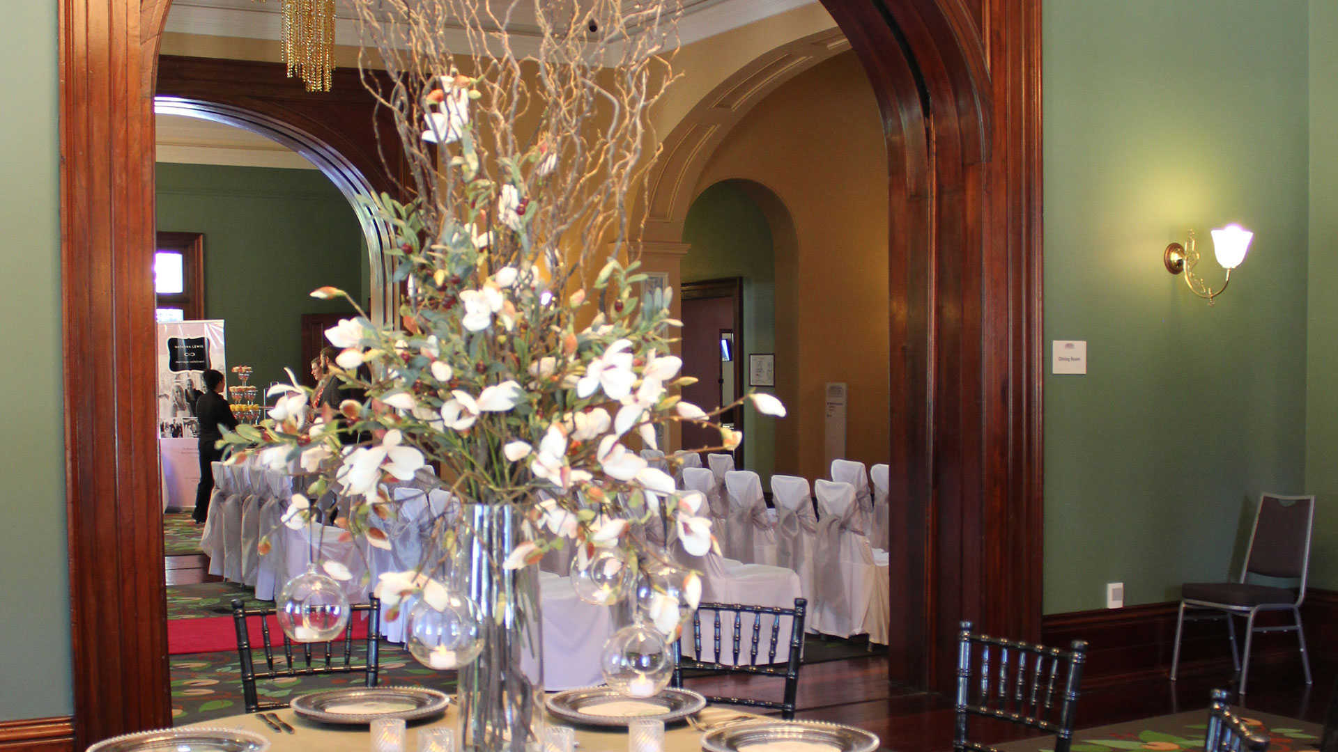 Room set for dinner with flowers